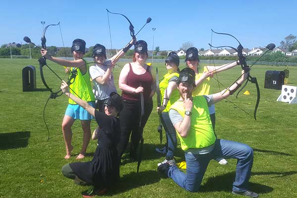 Archery Tag players in a victorious group pose