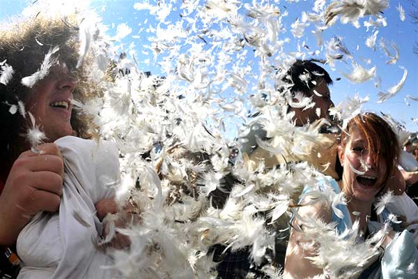Pillow fight with feathers in the air