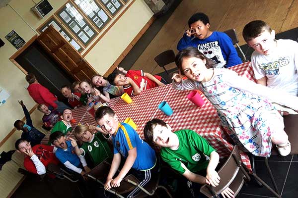 Kids having some nuggets and chips after a birthday party bubble football game.